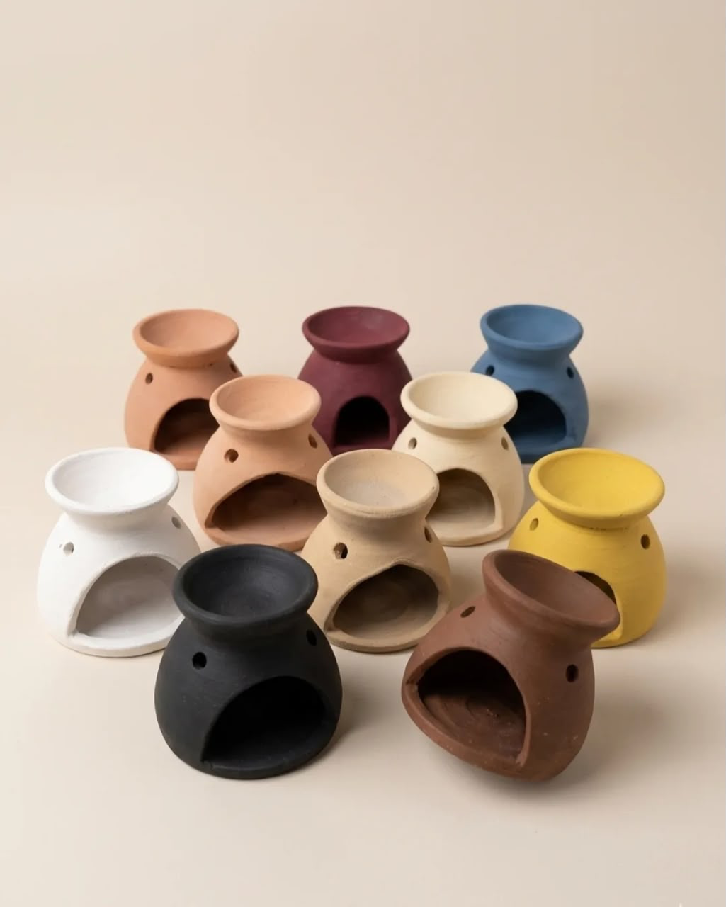 Group of small hand-built vessels in varied clay colours